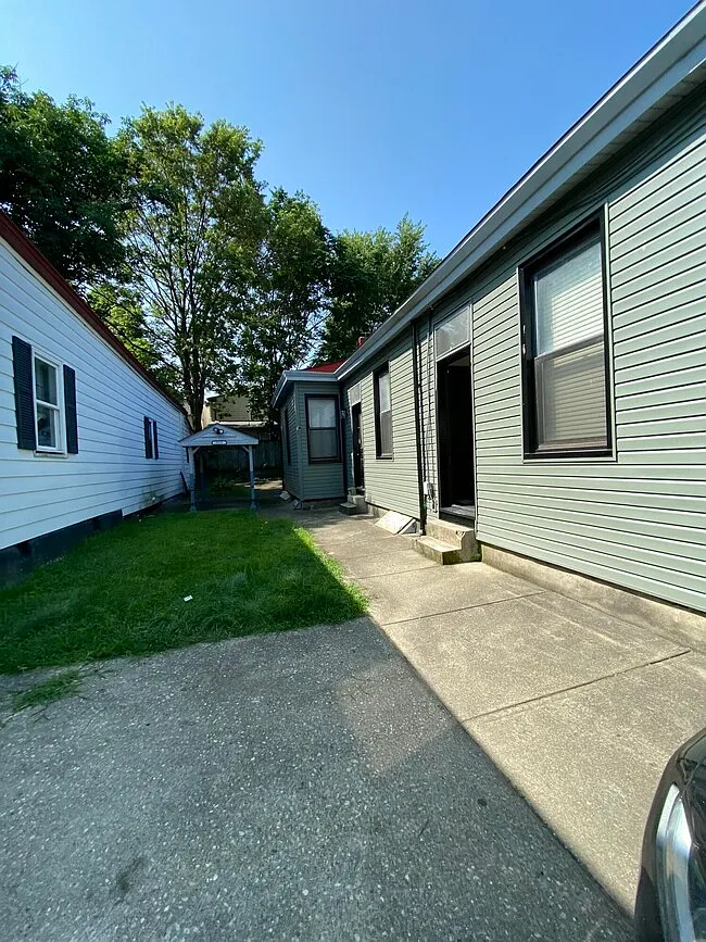 Side entrance and driveway walkway alongside the home